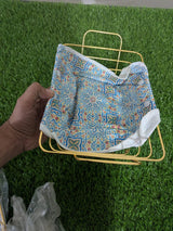 Close-up of patterned removable bread basket liner