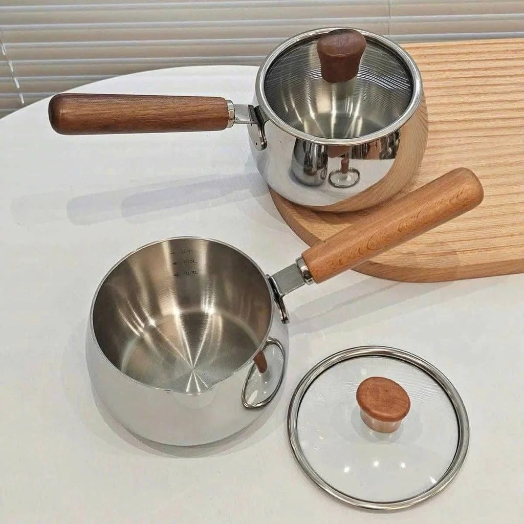 Close-up of stainless steel mini pots' interiors with lids