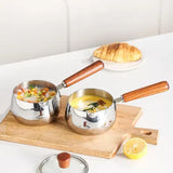 Two chubby stainless steel mini pots in kitchen use