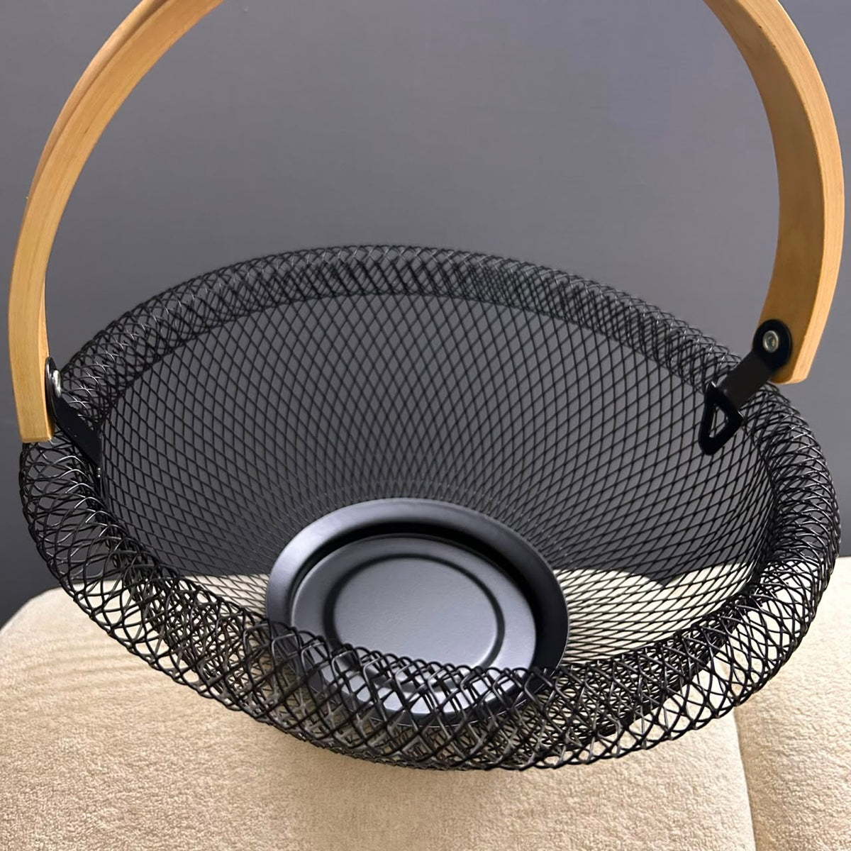 Interior view of round metal mesh fruit organizer with stable base